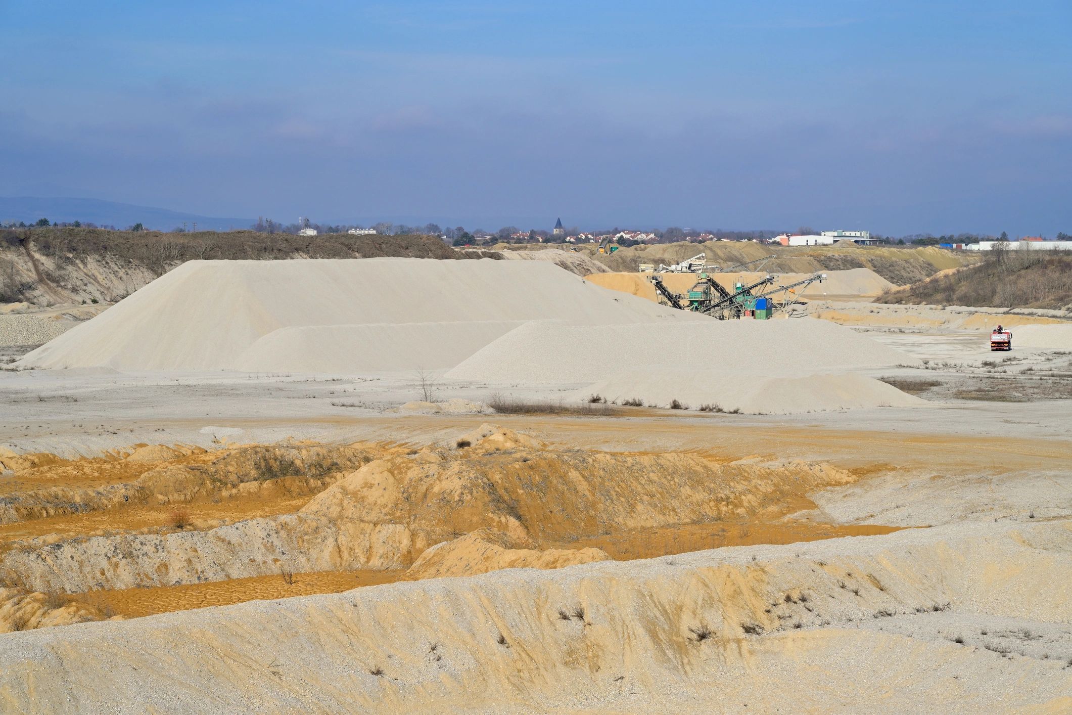 Quarry with piles of sand and gravel used for construction materials